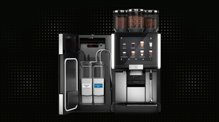 WMF automatic professional coffee machine with digital display, dual bean hoppers, with attached milk refrigeration unit with integrated 2-milk system solution, on a dark dotted pattern background.