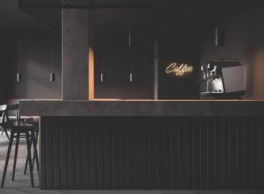 Dimly lit modern coffee bar with a sleek WMF espresso NEXT coffee machine, highlighted by ambient lighting and minimalist décor.